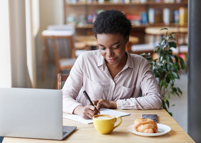 Credit repair specialist reviewing client notes and documenting account details during the credit report interview process.
