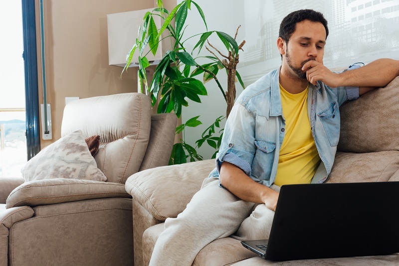 young man thinking about a credit repair software which is free