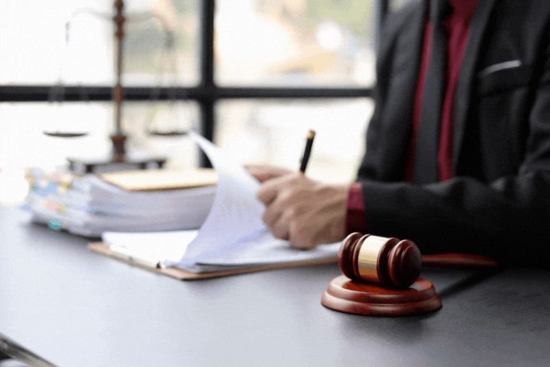 Business owner reviewing legal documents with a judge’s gavel, representing how to legally register a credit repair business before serving clients