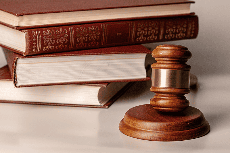 Wooden gavel and law books representing compliance requirements for credit repair automation software