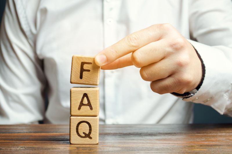 FAQ concept with wooden blocks representing common questions about credit repair business productivity, performance metrics, KPIs, and workflow management