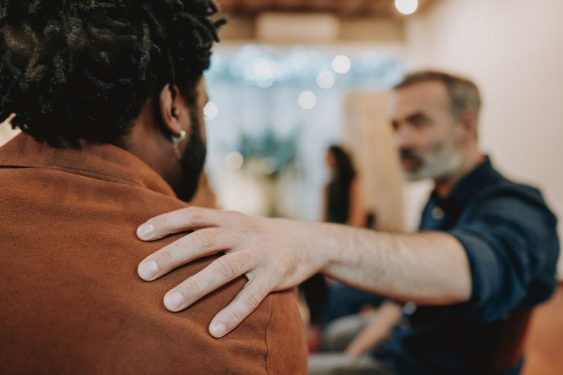 Two people in discussion representing the federal credit repair framework, including FCRA credit reporting laws, FDCPA debt collection rules, and TSR advance fee ban compliance