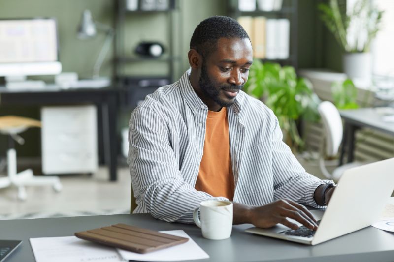 Man reviewing his credit report on a laptop to check for errors before starting a credit dispute process