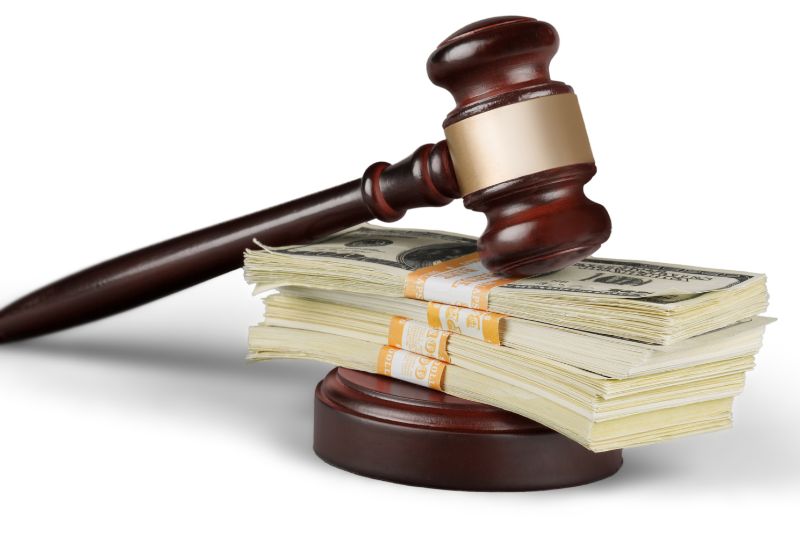 Judge gavel on cash stack representing legal limits on credit repair company charges, state fee caps, CROA advance fee rules, and regulated credit repair pricing