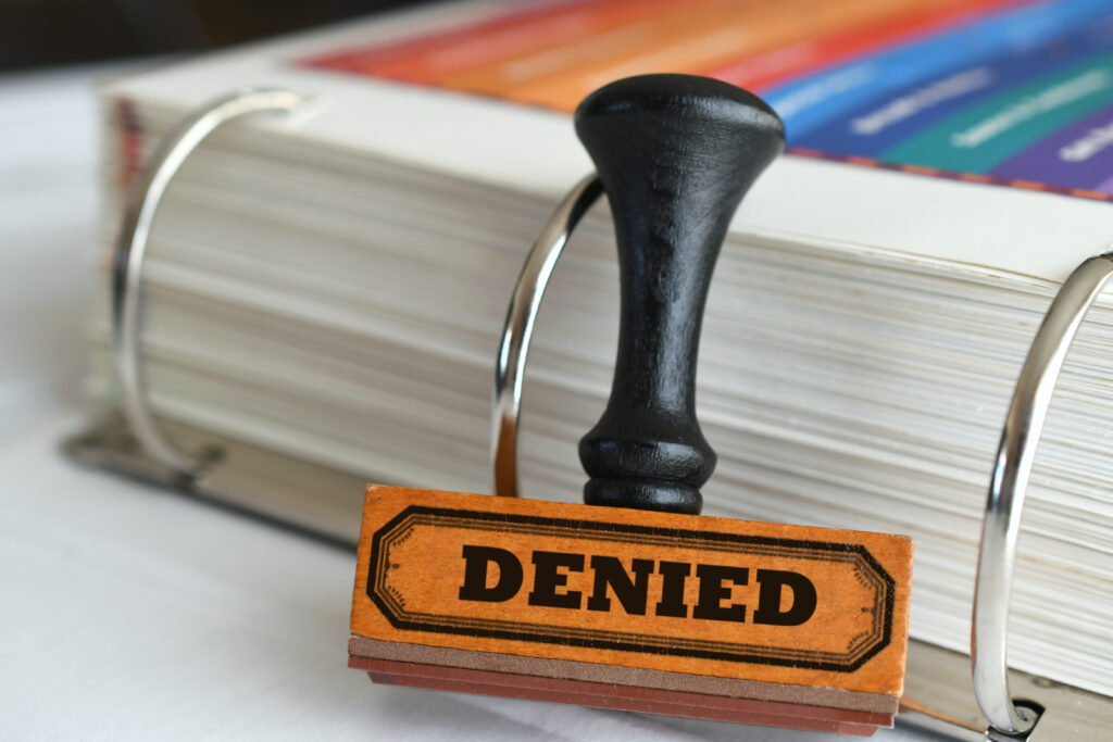 denied stamp on documents showing common reasons why public record dispute rejected on credit report including bankruptcy and civil judgment issues