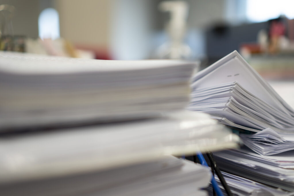 stack of documents representing what documentation to include when disputing a public record on a credit report