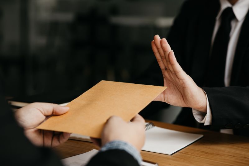 Person rejecting envelope symbolizing credit dispute denial due to subjective account interpretation issues, where disputes are rejected because they lack factual errors or verifiable evidence
