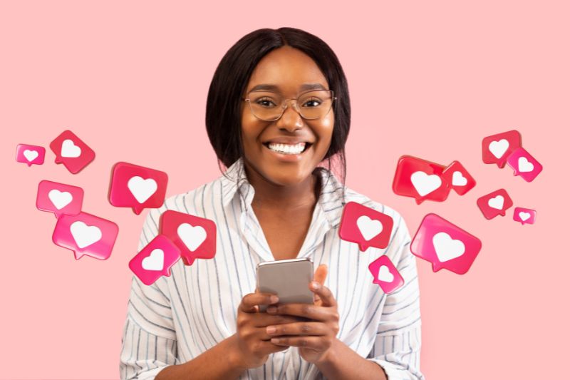 Woman using a phone with social media likes for Facebook and Instagram credit repair marketing to attract clients