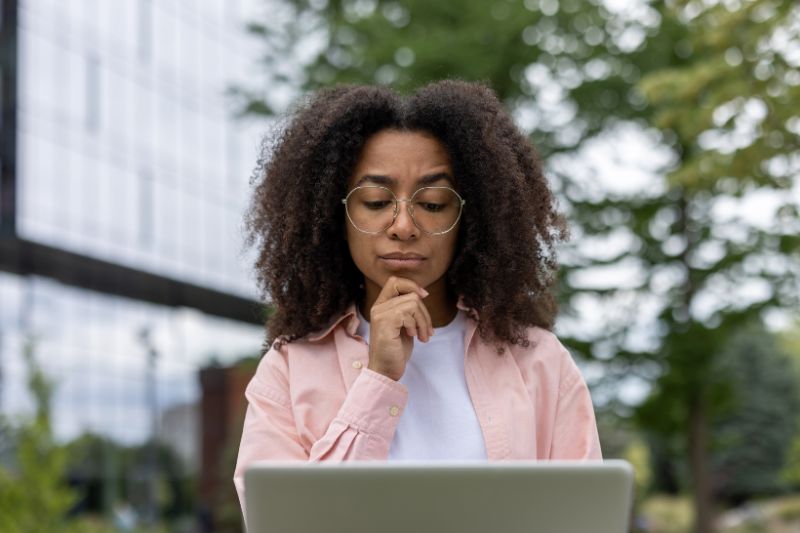 Woman researching consumer rights and financial recovery options in a private CROA lawsuit related to credit repair violations and compliance issues
