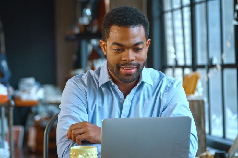 Business owner reviewing a credit repair marketing funnel on a laptop to convert leads into clients in 2026.