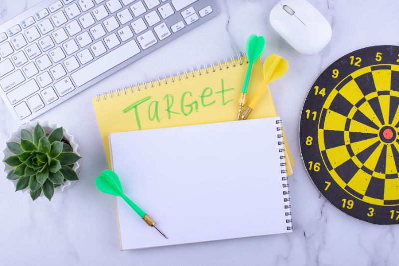 Dartboard and target notes representing credit repair marketing niche selection for a credit repair business in 2026.