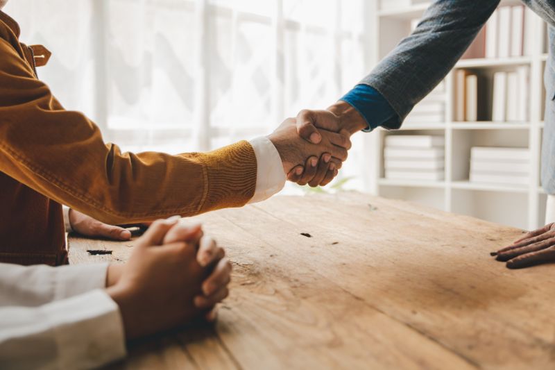 Mortgage broker and realtor discussing a home purchase as part of credit repair referral partnerships for mortgage-ready clients