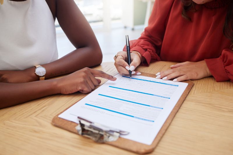 Credit repair software comparison checklist being reviewed by business professionals to compare features, client management, dispute tools, security, training, and support.