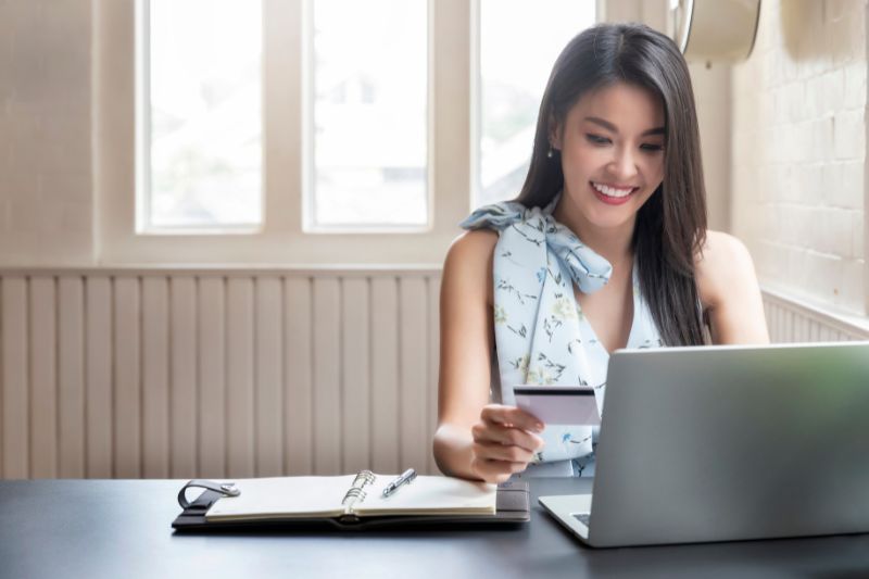 Credit report import process showing a user accessing report information on a laptop for credit repair software review