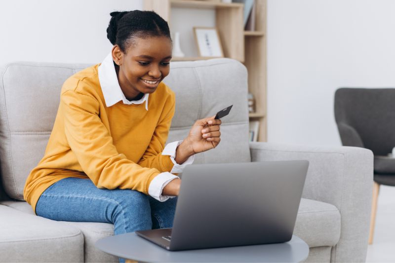 Woman comparing credit repair software online to choose the right platform for managing clients, disputes, and business workflows.