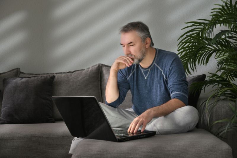 Staff member reviewing credit report information on a laptop before approving credit repair actions